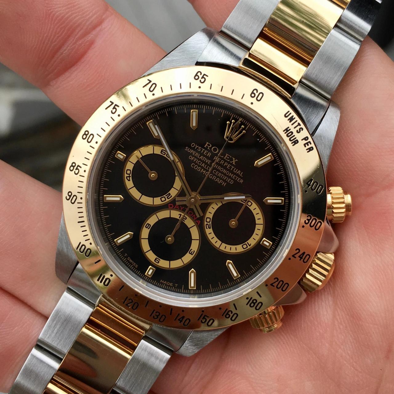 Rolex daytona gold black dial